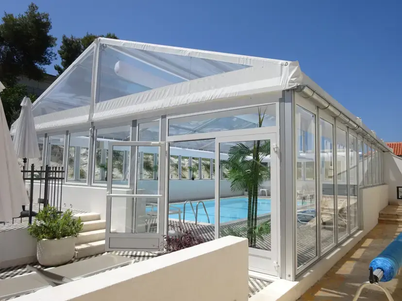 Temporary transparent tent structure covering hotel swimming pool in Australia