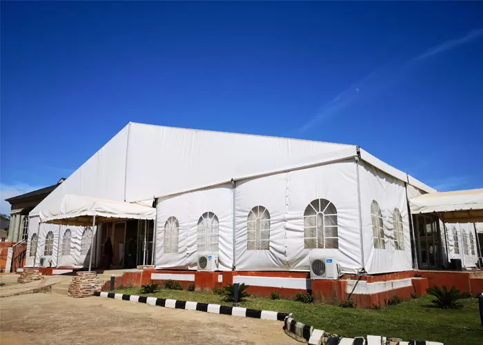 25x30m USA revival church tent with white PVC roof and aluminum frame, set up on grass field
