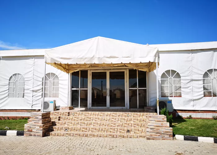 Side view of 25x30m church event tent with arched PVC windows and reinforced sidewalls for ventilation

