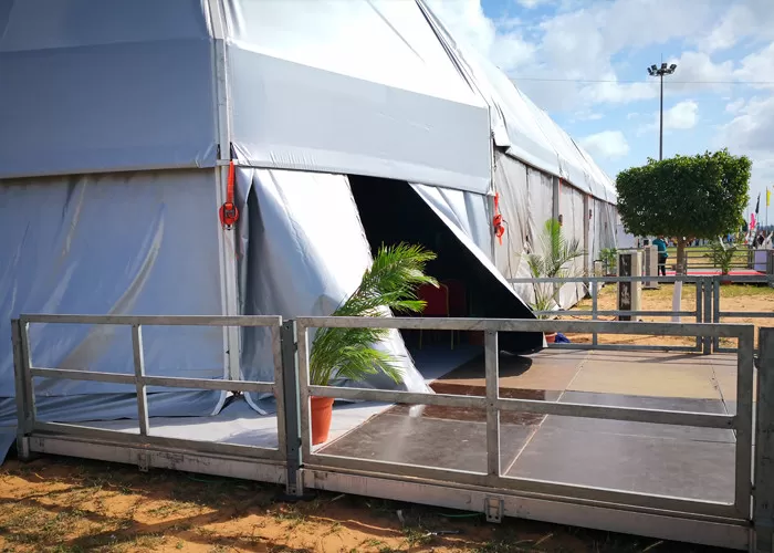 Wide-angle outdoor shot of 10x50m corporate event tent at venue