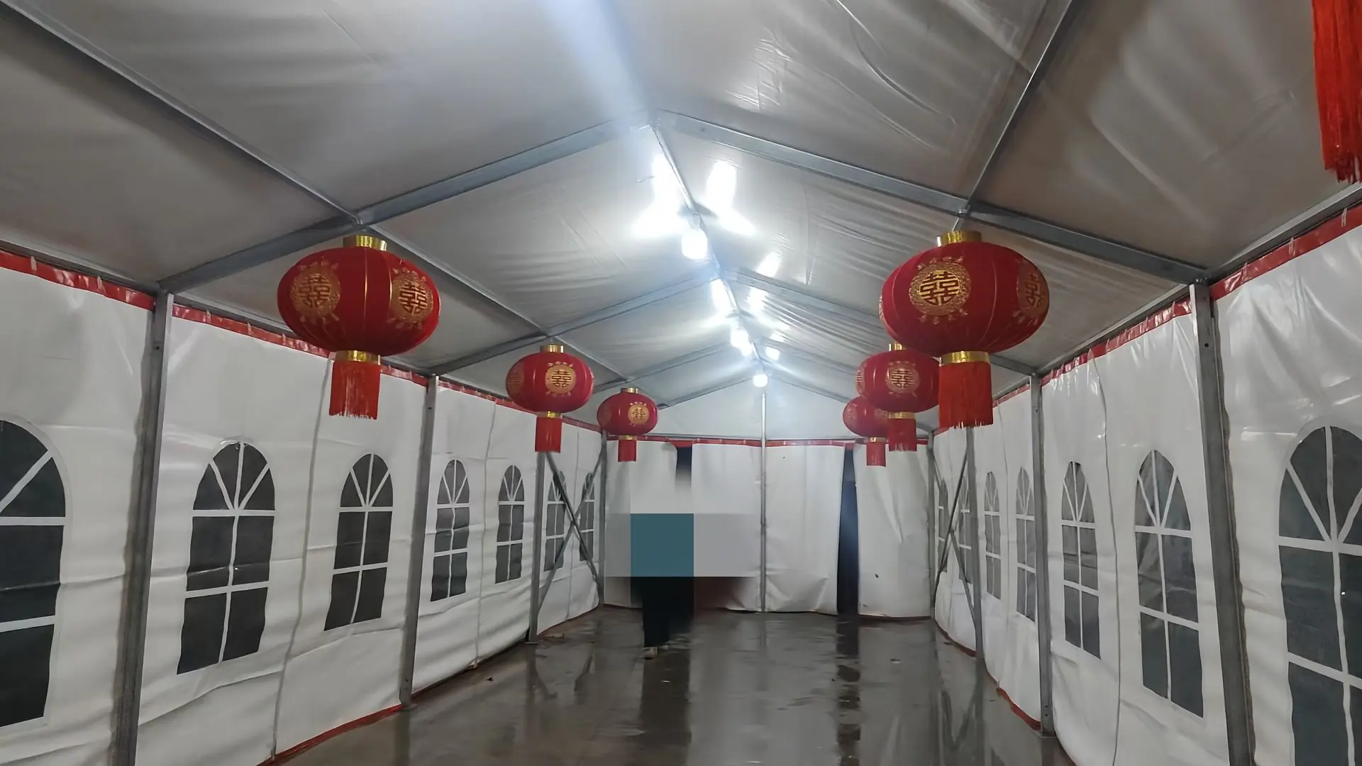 Interior of the 24x6m wedding tent with white draped ceiling and banquet-style seating layout